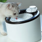 A cat drinking from an Automatic Drinking Machine For Cats