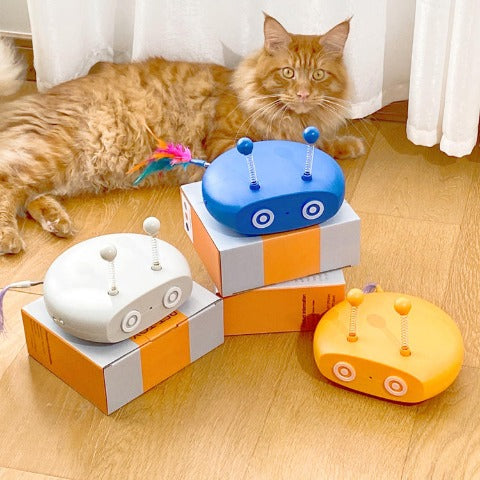 A cat next to 3 types of Cat Teasing Robot Laser Toys