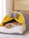 A cat sleeping in a milky yellow cat cocoon