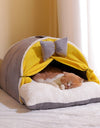 A cat sleeping in a best milky yellow cat cocoon