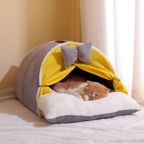 A cat sleeping in a best milky yellow cat cocoon