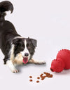 Red Food Dispensing Toy next to a dog