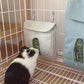 Guinea pig smelling a Pet Food Bag in a cage