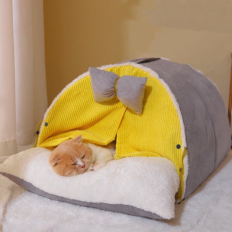 A cat sleeping in a milky yellow cozy cat cocoon 